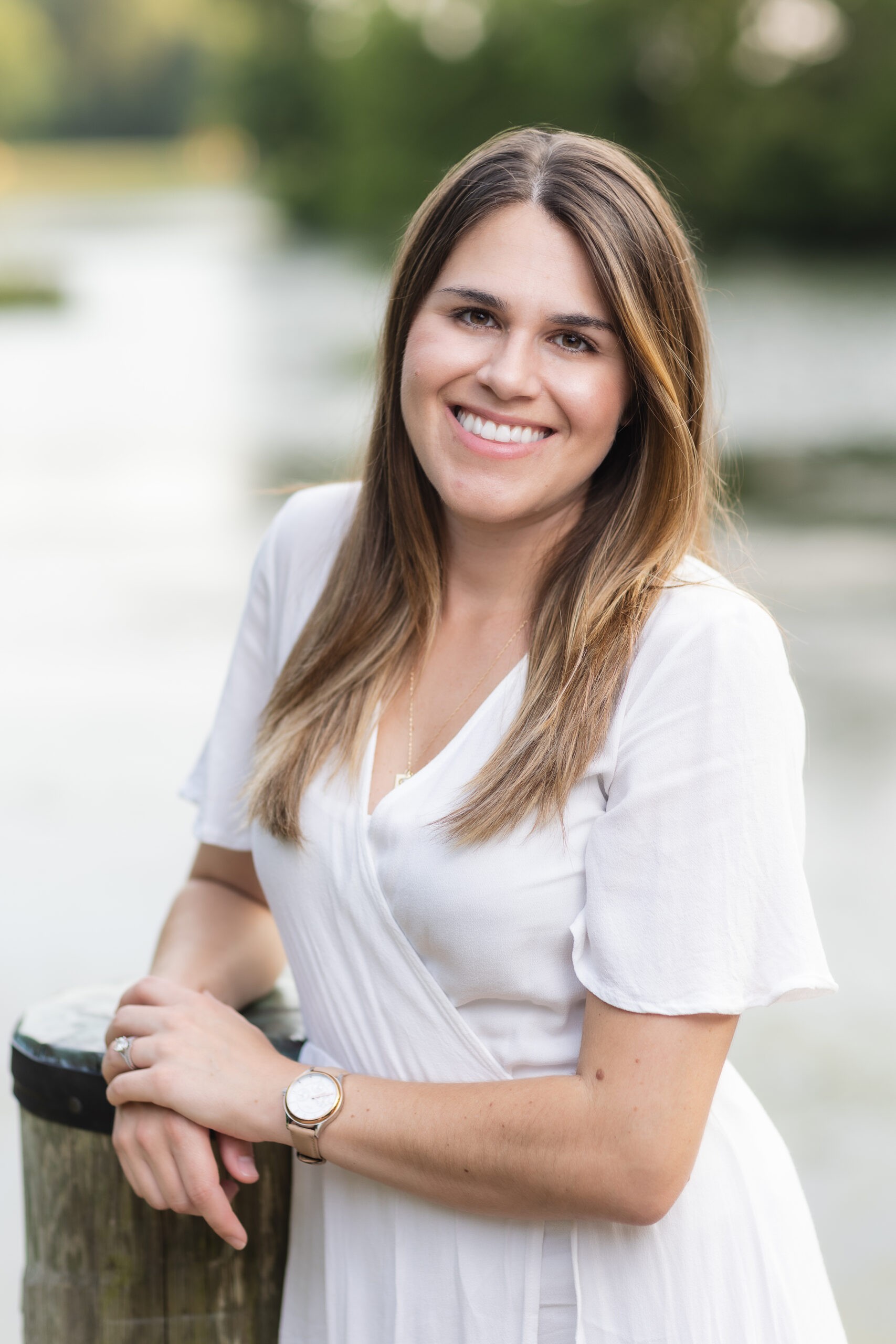 Stylized blue duotone portrait of a person facing the camera with arms crossed